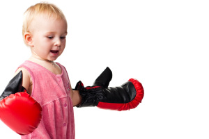 Beautiful baby in boxing gloves punching